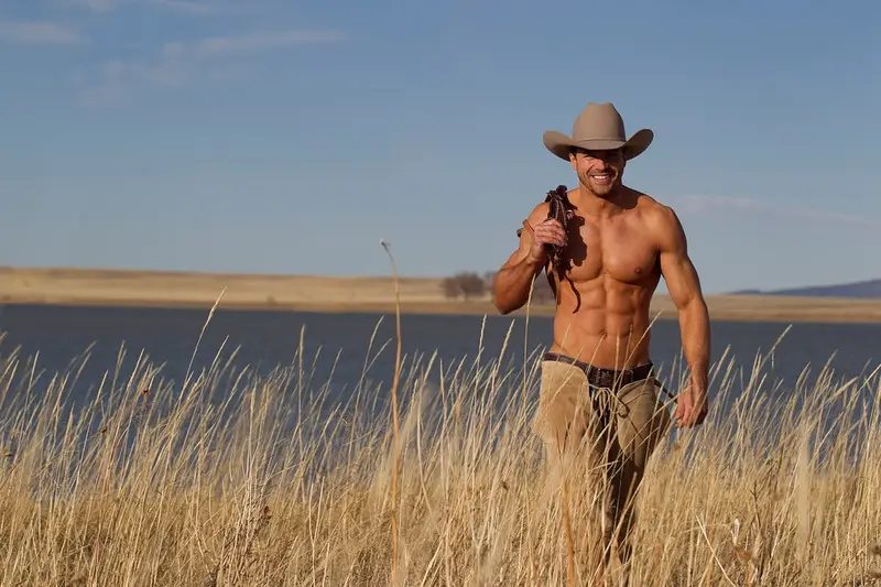 sexy-shirtless-cowboy-walking-in-a-field