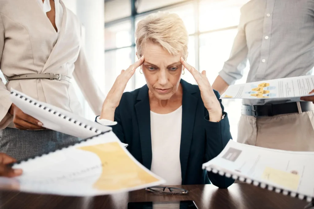 Business woman, stress, burnout and documents with staff question