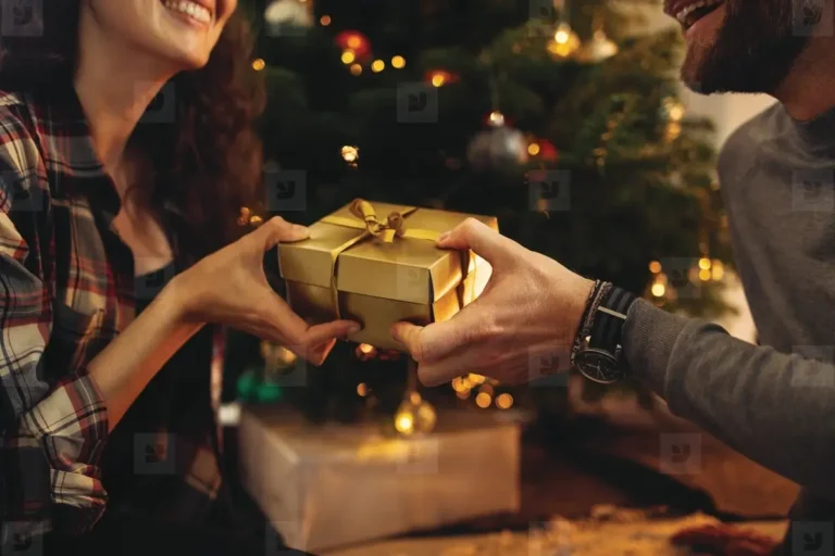 Romantic Couple Exchanging Christmas Gifts